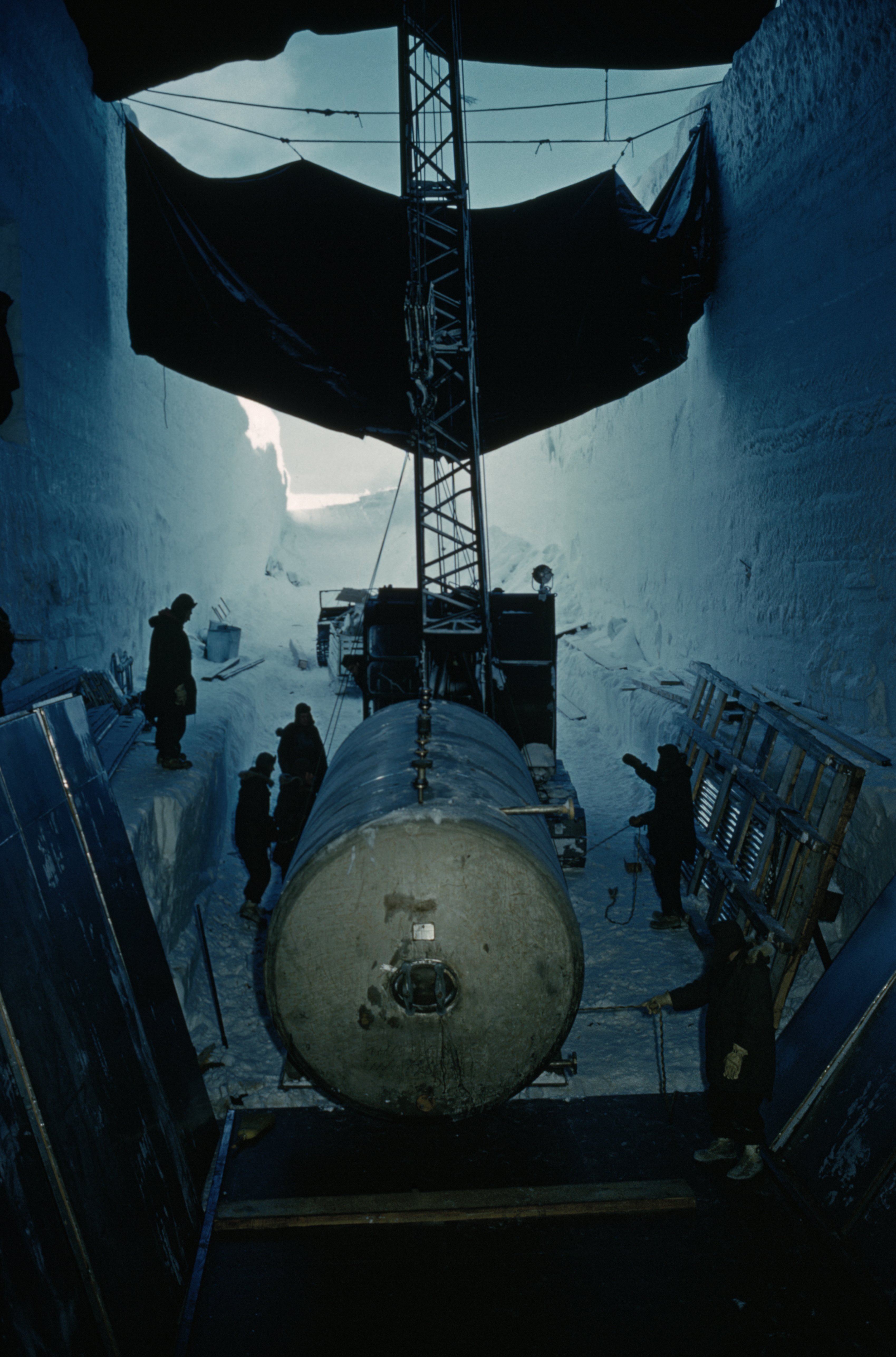 Crane positions nuclear plant's waste tank, Camp Century, Greenland
