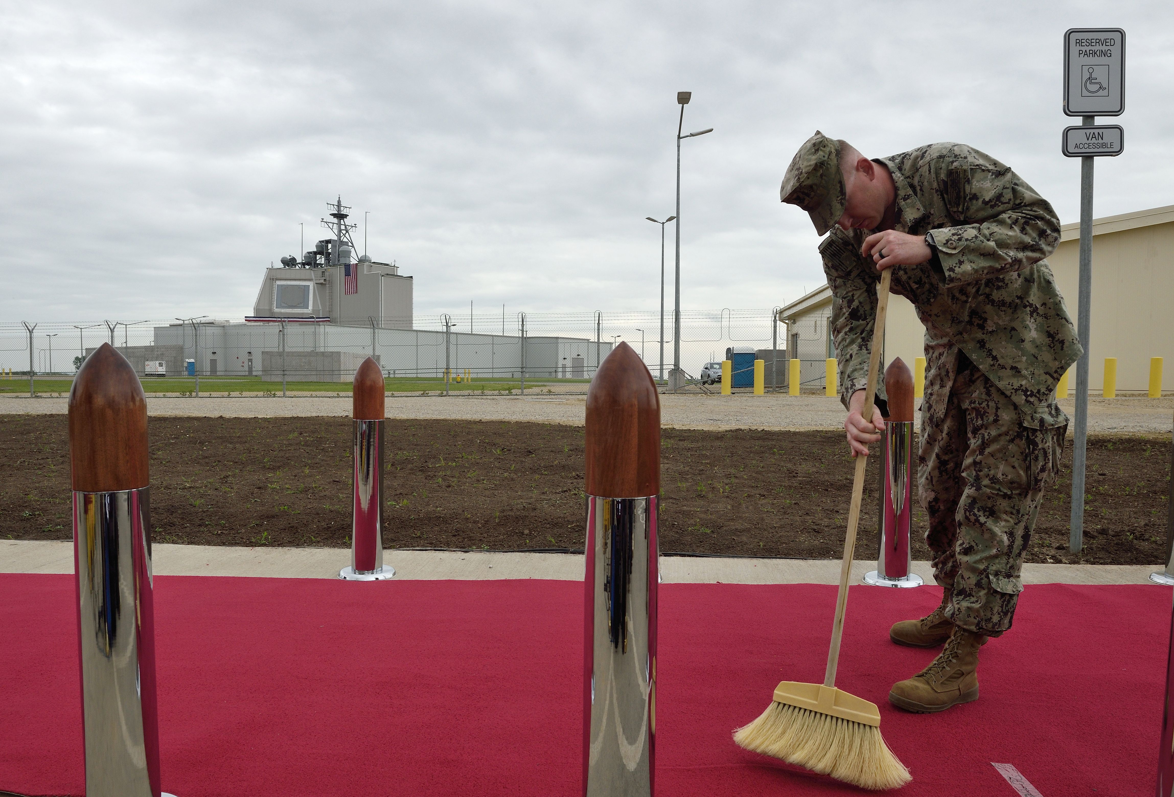 soldier sweeps red carpet
