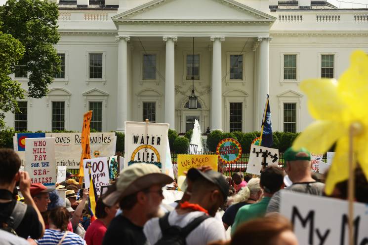 Demonstrators march near the White House on April 29, 2017. People came out to protest President Donald Trump’s attacks on climate policies.