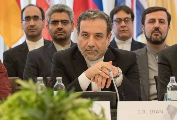 Group of Iranian officials sit at a table