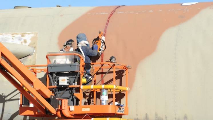 crews cut an airplane