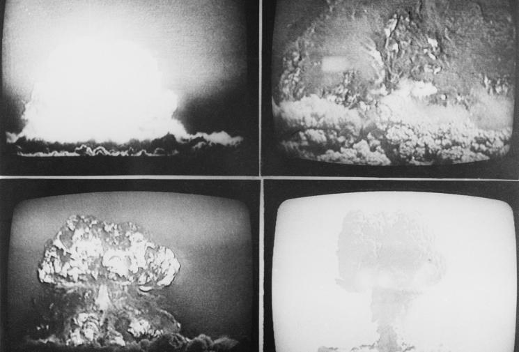Four televisions screens are shown in a grid, with four different mushroom clouds visible.