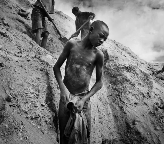 Boy stands on a hillside