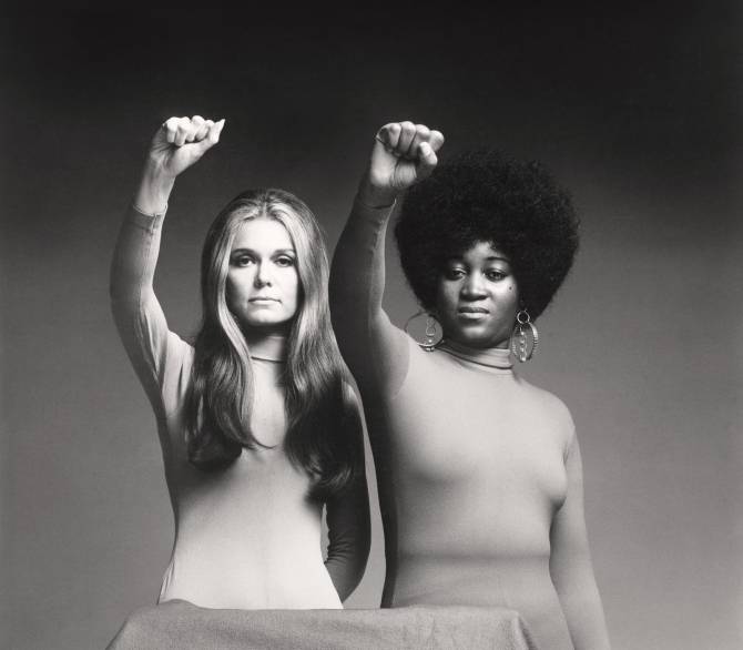 two women with raised fists