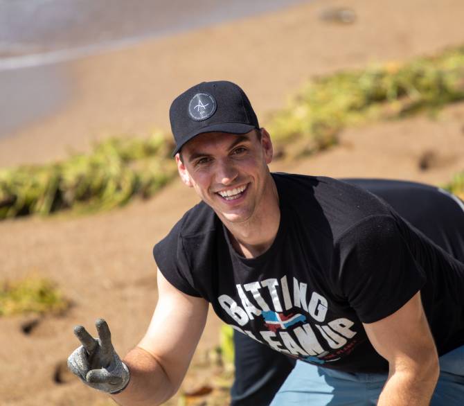 Brent Suter cleaning the beach in the Dominican Republic; Palm Creative 