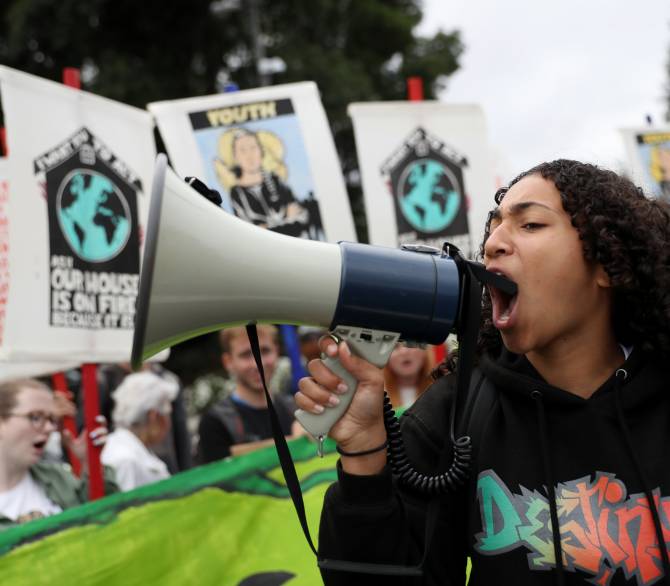 A youth climate activist uses a bullhorn as she leads a chant during a Climate Strike youth protest outside of Chevron headquarters on September 27, 2019 in San Ramon, California. Hundreds of youth climate activists and their supporters staged a Climate Strike protest outside of Chevron headquarters calling for the company to abandon fossil fuels by 2025.