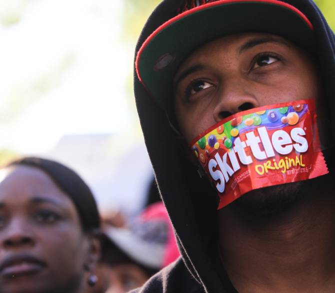 protestor with skittles bag taped to his mouth