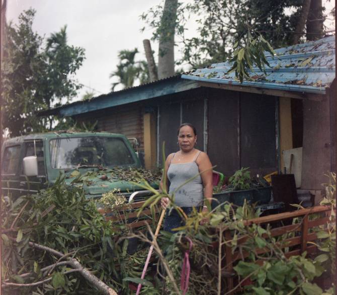 Anniesia Maderzo, a Filipina who has lived in Palau for nearly 15 years, dealing with storm damage at her home