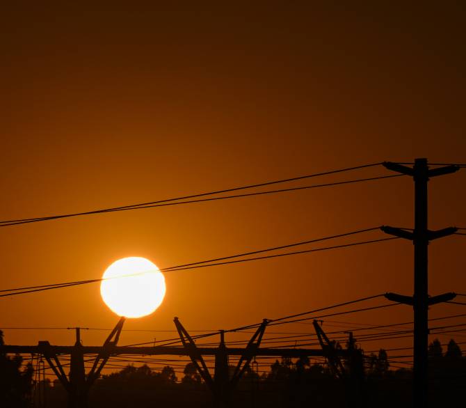 Power lines in the setting sun; Getty