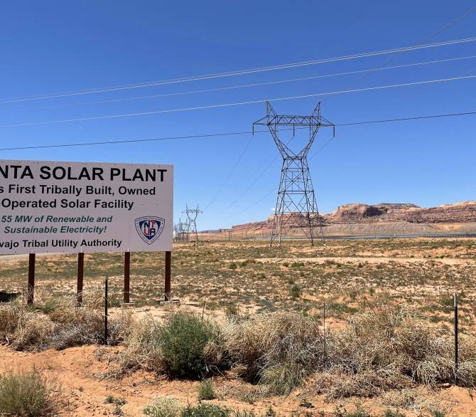 Motorists traveling on U.S. Highway 163 to the Monument Valley Navajo Tribal Park drive past the Navajo Tribal Utility Authority’s Kayenta Solar Farm outside of Kayenta, Arizona