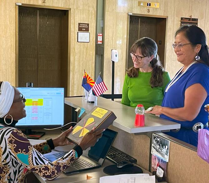 Sandy Bahr (center), director of Sierra Club's Grand Canyon Chapter, and Carletta Tilousi (right), member of the Havasupai Tribe, deliver a petition to the Arizona State Capitol Executive Tower in Phoenix on June 27. Credit: Noel Lyn Smith/Inside Climate News