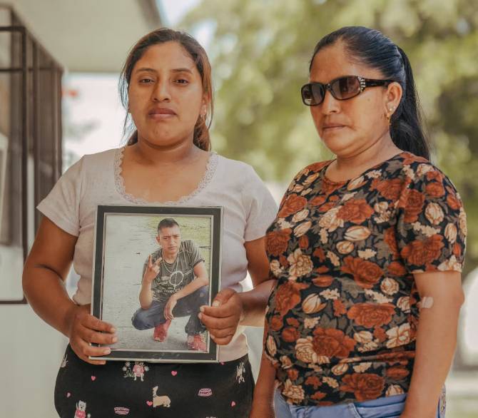 Efrain López García, who died at work on a fruit farm during an extreme heat wave in 2023, in a photograph held by his sister alongside his stepmother, Maria, in Homestead, Florida.