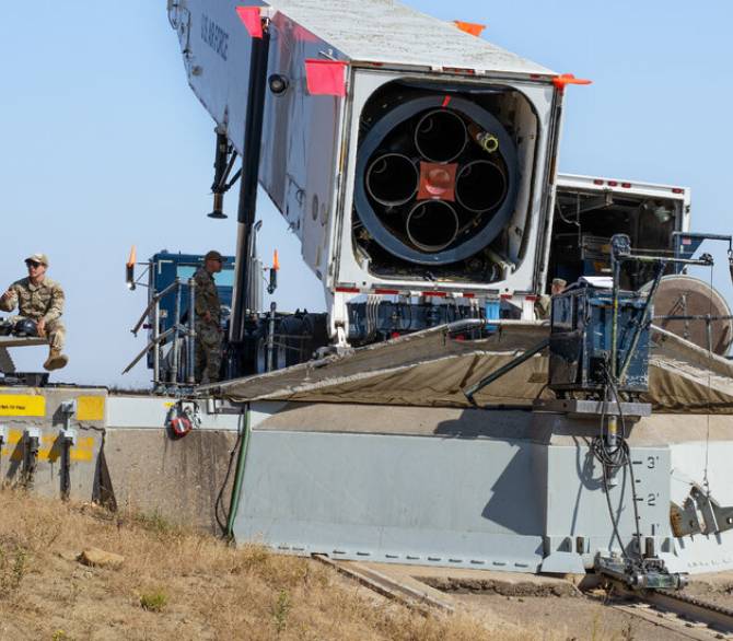 During an install, a towering missile is loaded into a specially modified tractor-trailer that tilts above the silo and then is lowered, inch by inch, underground.