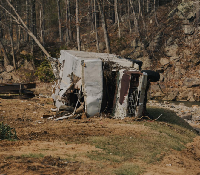 An RV sits among debris on 31 January, four months after Hurricane Helene struck in Barnardsville, North Carolina. The cleanup in some rural areas affected by the hurricane has been slow, and the rebuilding process has yet to begin.