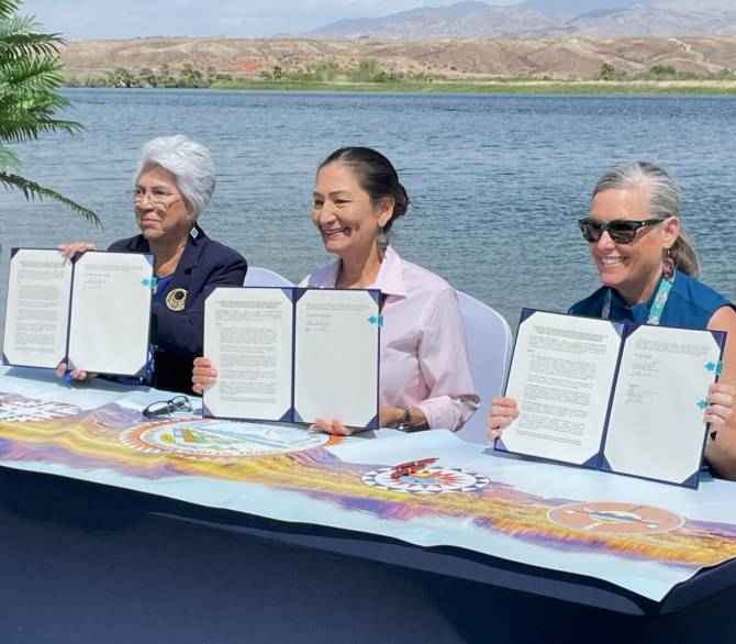 From left: Amelia Flores, Colorado River Indian Tribes chairwoman, Secretary of the Interior Deb Haaland and Arizona Gov. Katie Hobbs approve the tribe’s authority to lease, exchange or store its portion of Colorado River water.