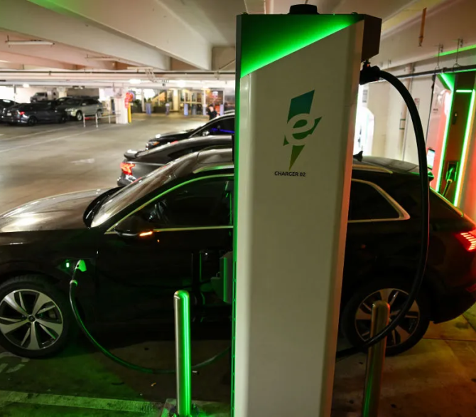 n electric Audi SUV charges at a public Electrify America EV DC fast charger in Los Angeles in May.