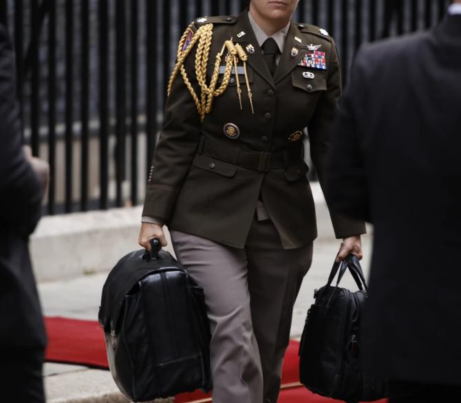 A military aide carries the Presidential Emergency Satchel, also known as the 