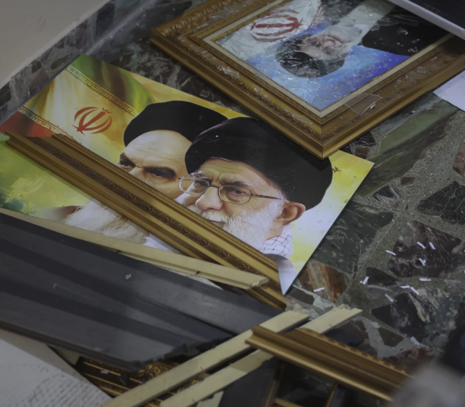 Broken pictures of Iranian spiritual leaders Ayatollah Ali Khamenei and Ayatollah Ruhollah Khomeini lie on the floor at the Iranian embassy after opposition forces took control of the city in Damascus, Syria, Sunday, Dec. 8, 2024. 