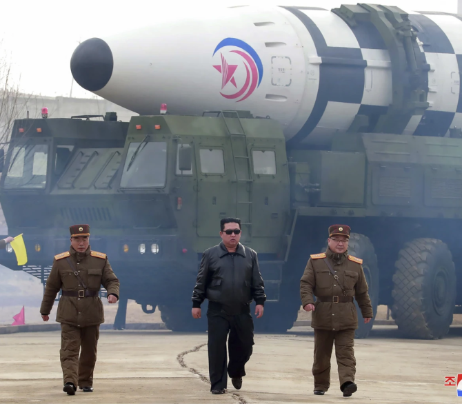 In this photo distributed by the North Korean government, North Korean leader Kim Jong Un, center, walks around what it says is a Hwasong-17 intercontinental ballistic missile (ICBM) on the launcher at an undisclosed location in North Korea on March 24, 2022. Independent journalists were not given access to cover the event depicted in this image distributed by the North Korean government. The content of this image is as provided and cannot be independently verified. Korean language watermark on image as pro