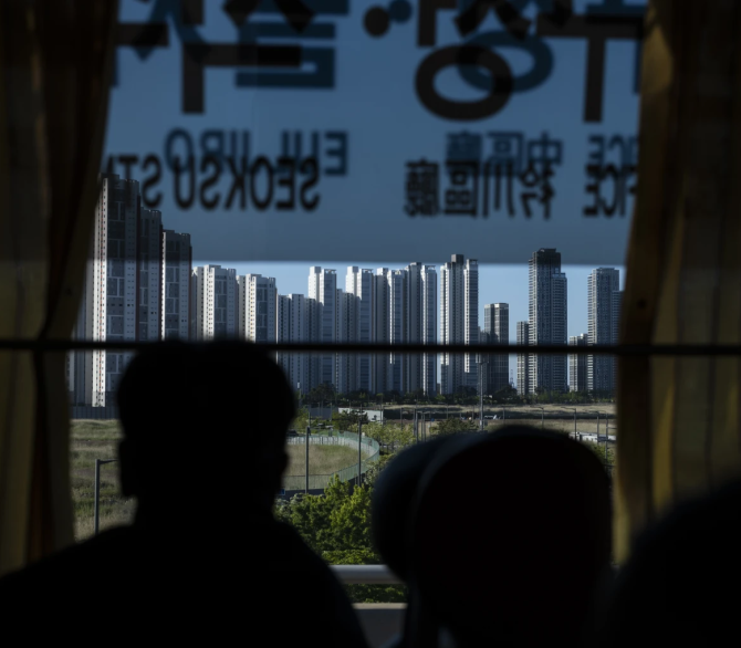 A tourist views high-rise apartment buildings from a bus in Incheon, South Korea, Thursday, May 16, 2024. 