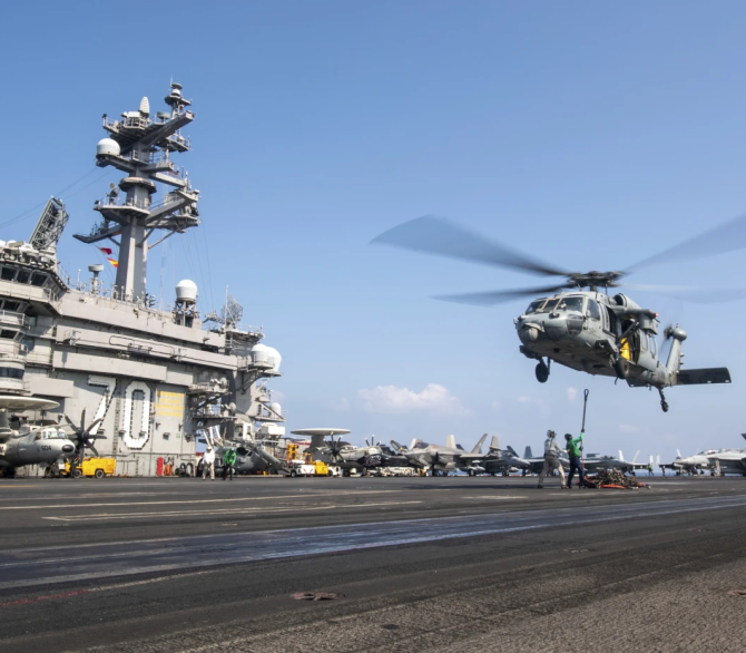 This photograph released by the U.S. navy shows a MH-60S Sea Hawk helicopter hovering over the USS Carl Vinson aircraft carrier while operating in the Middle East on April 12, 2025. 