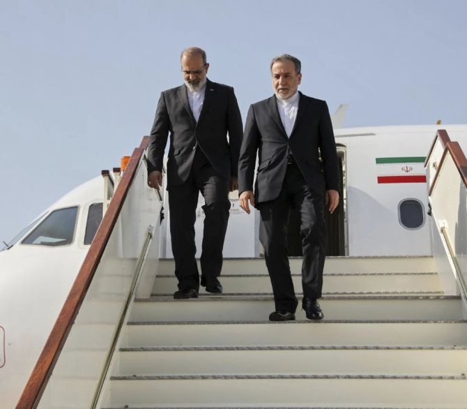 In this photo released by Iranian Foreign Ministry, Iranian Foreign Minister Abbas Araghchi, right, steps out from his plane as he arrives at Muscat, Oman, Friday, April 25, 2025, a day prior to negotiations with U.S. Mideast envoy Steve Witkoff. 