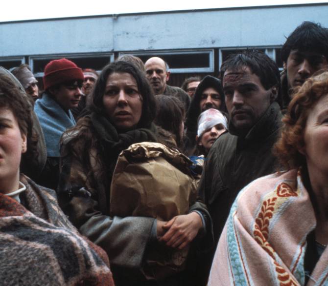 Karen Meagher as Ruth Beckett in Threads, surrounded by unidentified females and males, arriving at hospital.
