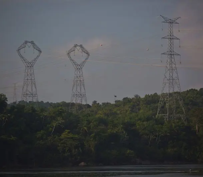 Transmission towers that connect power lines to the Belo Monte hydroelectric dam stand near the Xingu river in Para, Brazil, on Saturday, Dec. 20, 2014.