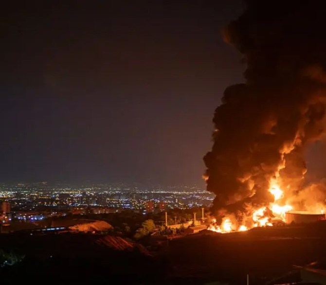 Fire and smoke rise into the sky after an Israeli attack on the Shahran oil depot on June 15, 2025 in Tehran, Iran. 