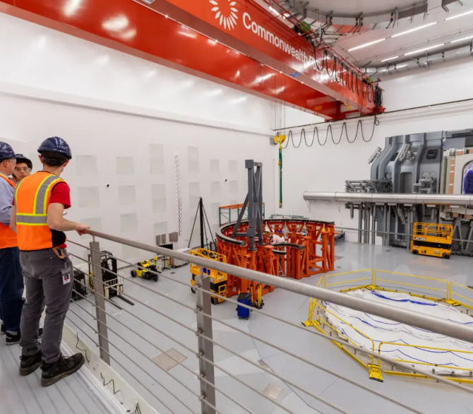 Workers assemble a frame that will hold Commonwealth Fusion's SPARC tokamak demonstration system at the company's campus in Massachusetts, in November. 