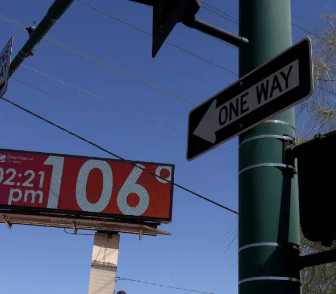 A billboard shows the current temperature over 100 degrees in June 2024 in Phoenix.
