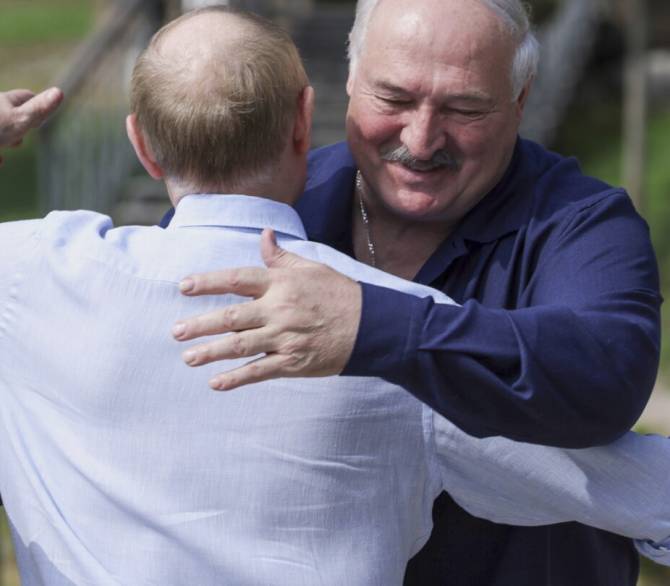 Russian President Vladimir Putin, front, embraces Belarusian President Alexander Lukashenko during their visit to the Smolensky Skete of Valaam Monastery at Valaam island in Ladoga lake, Republic of Karelia, Russia, Friday, Aug. 1, 2025.