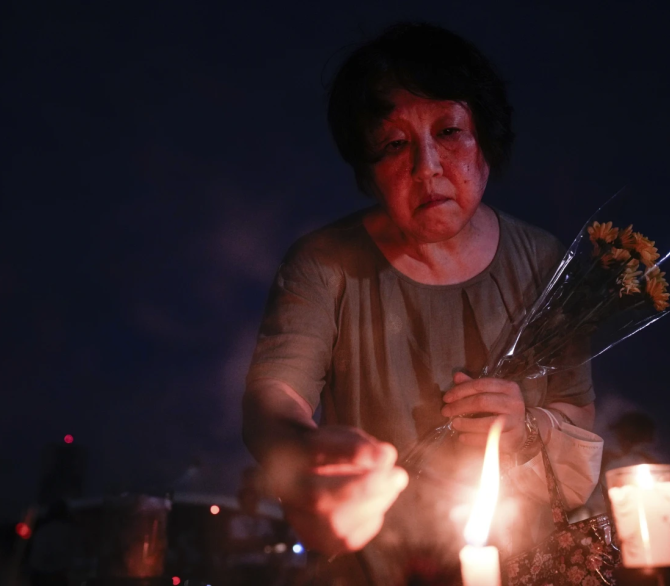 A visitor lights incense sticks at the Peace Memorial Park ahead of the memorial service to mark the 80th anniversary of the WWII U.S. atomic bombing in Hiroshima, Wednesday, Aug. 6, 2025, in Japan.