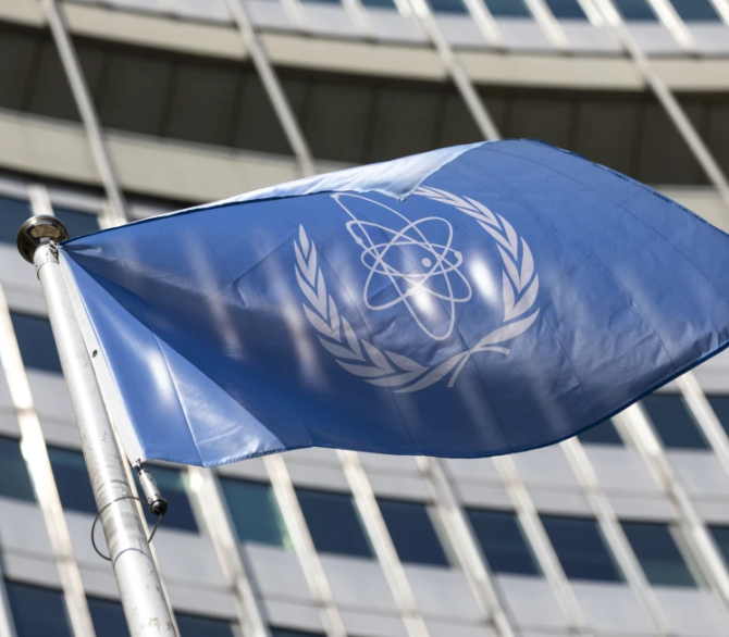 In this June 7, 2021, file photo, the flag of the International Atomic Energy Agency (IAEA) waves at the entrance of the Vienna International Center in Vienna.