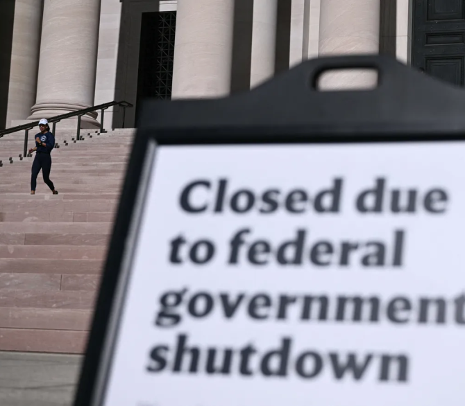People enjoy the weather at the closed National Gallery of Art in Washington, DC, on Oct. 20, 2025. The US government shutdown dragged into a third week, with Congress gridlocked in a clash over spending and no resolution in sight to a crisis that has already cost thousands of jobs.