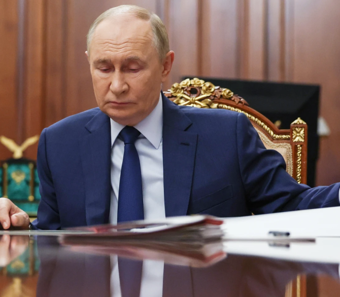 Russian President Vladimir Putin attends a meeting with Russian Deputy Prime Minister Dmitri Patrushev at the Kremlin in Moscow, Russia, Monday, Oct. 6, 2025.