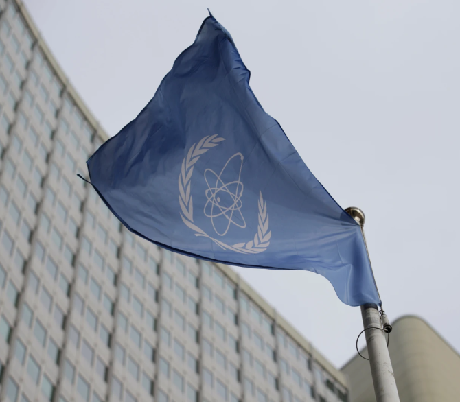 The flag of the International Atomic Energy Agency flies in front of its headquarters during an IAEA Board of Governors meeting in Vienna, Austria, on Feb. 6, 2023.