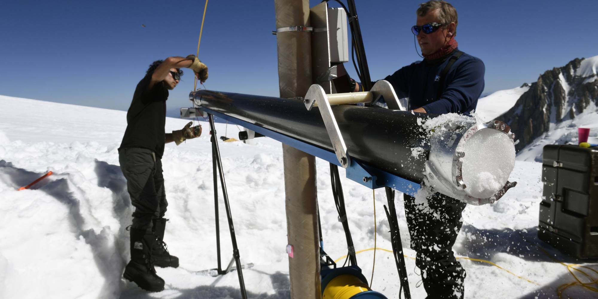 scientists extract an ice core