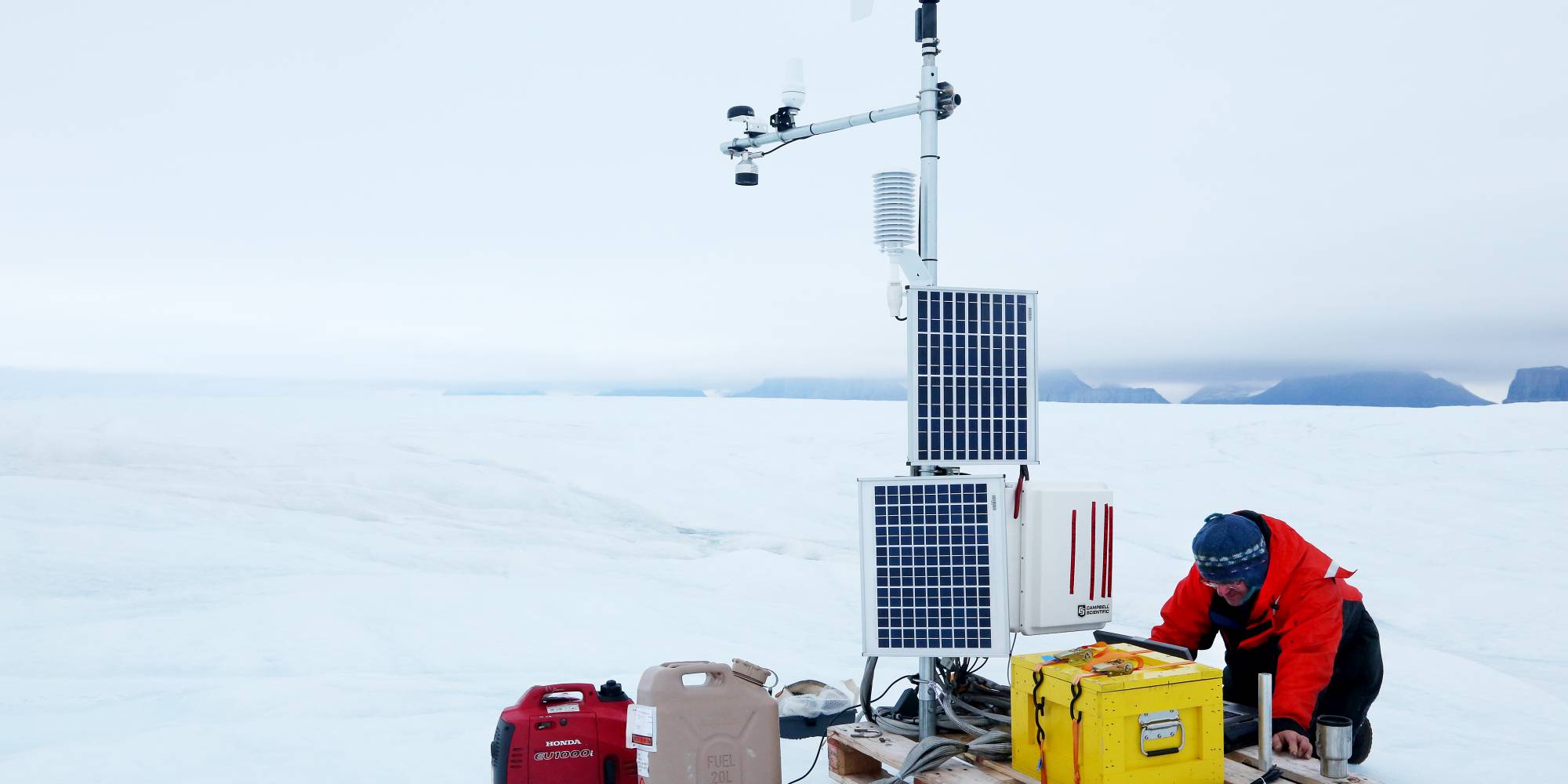 Scientist works with a portable weather station in the Arctic