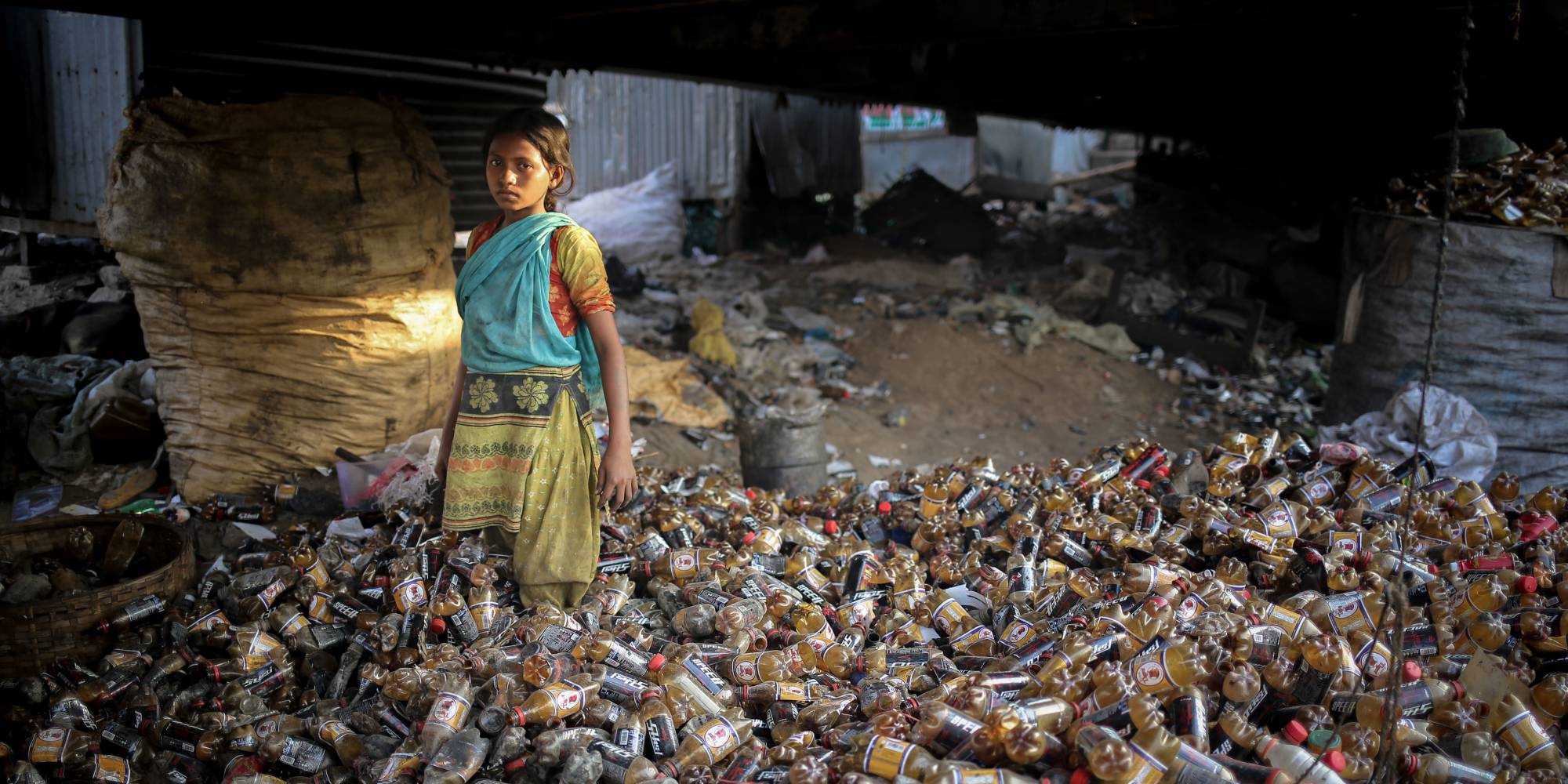 young girl in plastic bottle recycling facility